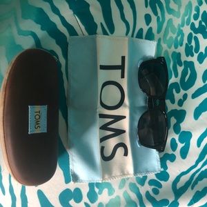 Black TOMS sunglasses with light blue and cream